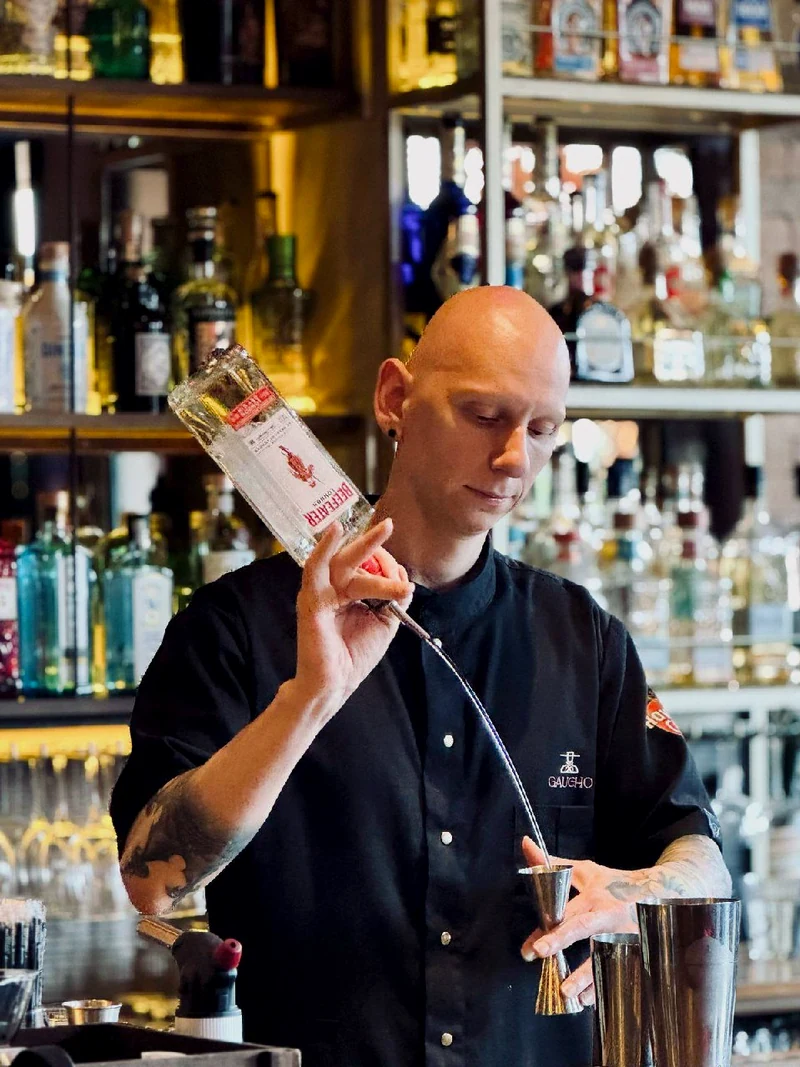 Bartender pouring drinks behind the bar