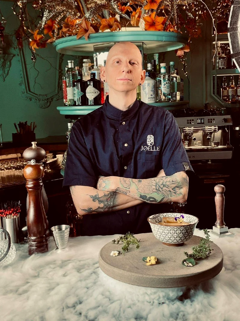 Bartender in uniform behind the bar